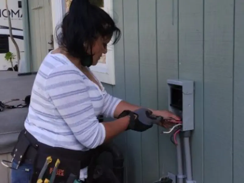 Licensed electrician wiring an exterior subpanel in Marcellus